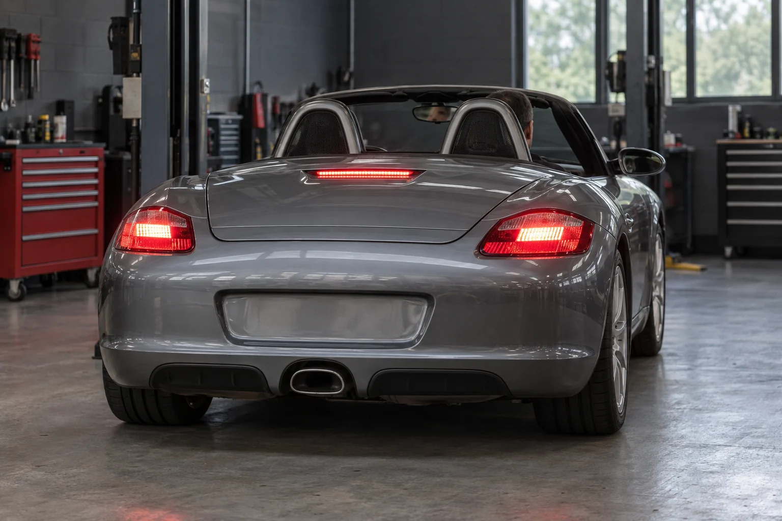 Grey Boxster with its rear brake lights and centre stop lamp illuminated