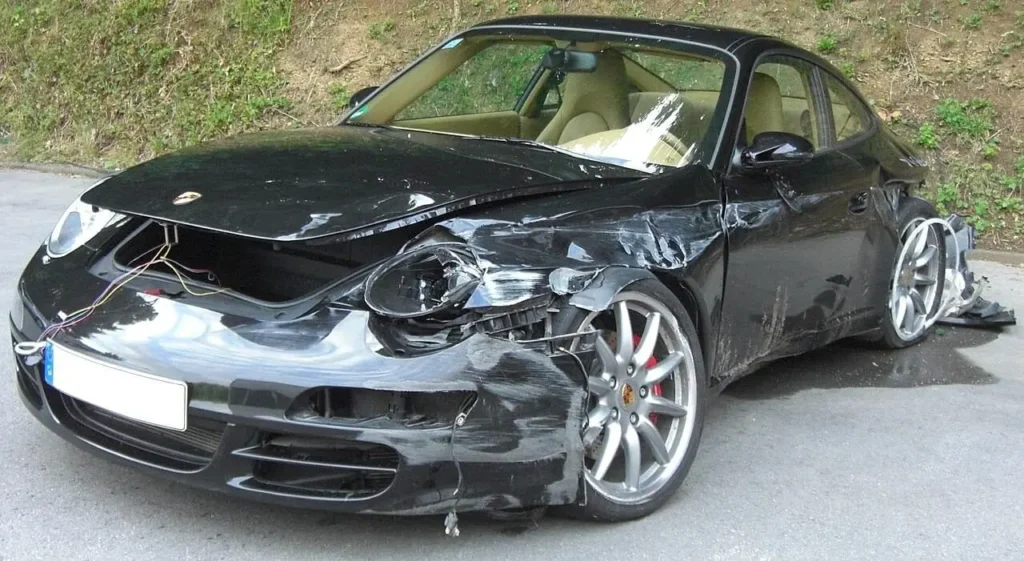 Collision-damaged Porsche 911 with damage to the front and side panels