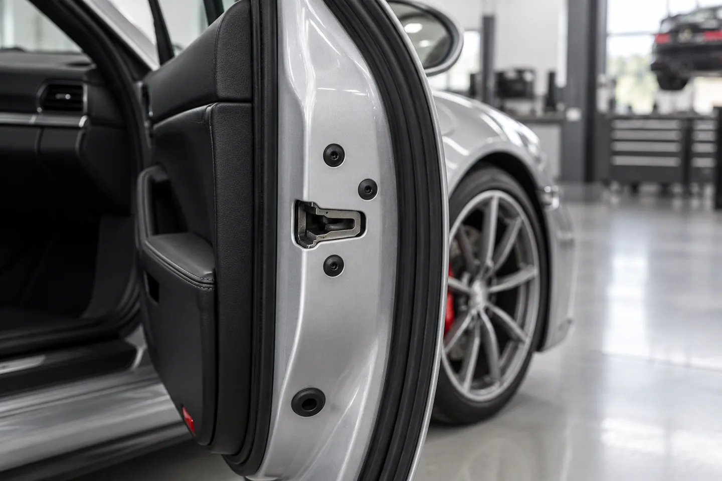 Latch on the rear edge of an open sports-car door, illustration