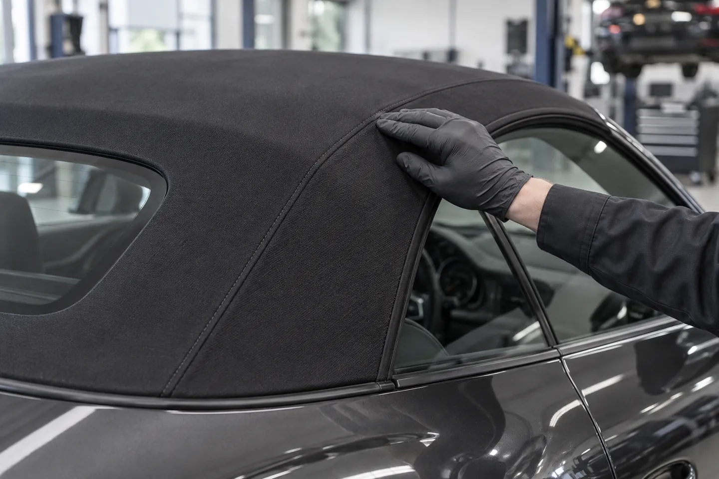 Technician inspecting a seam in convertible roof fabric